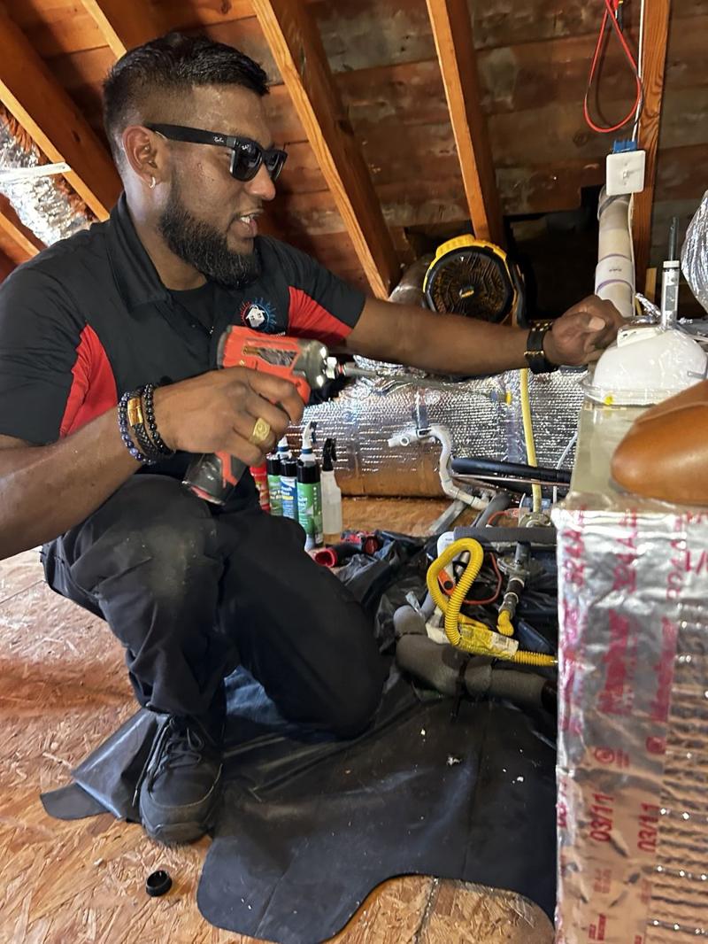 Josh servicing an attic air handler